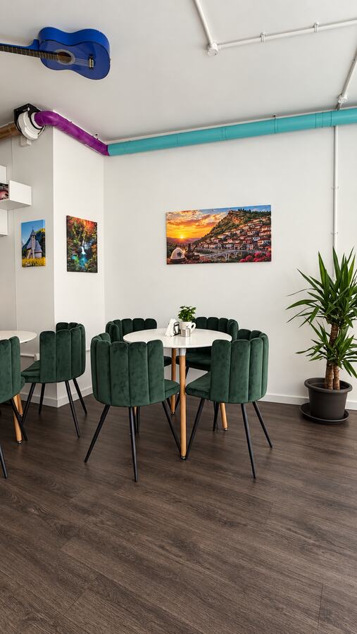 Inside Cataleya's Café with green velvet chairs and white tables